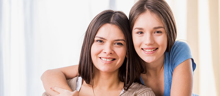 portrait photo of mother and daughter, smiling